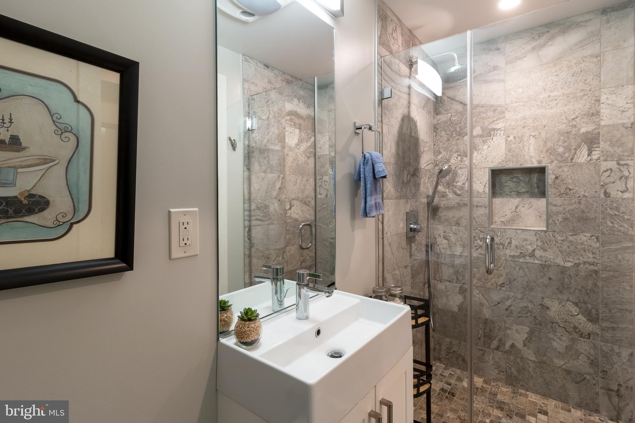 4514 15th Street Northwest, Unit B Washington, DC 20011 - Photo 11 of 34 a bathroom with a sink a toilet and shower