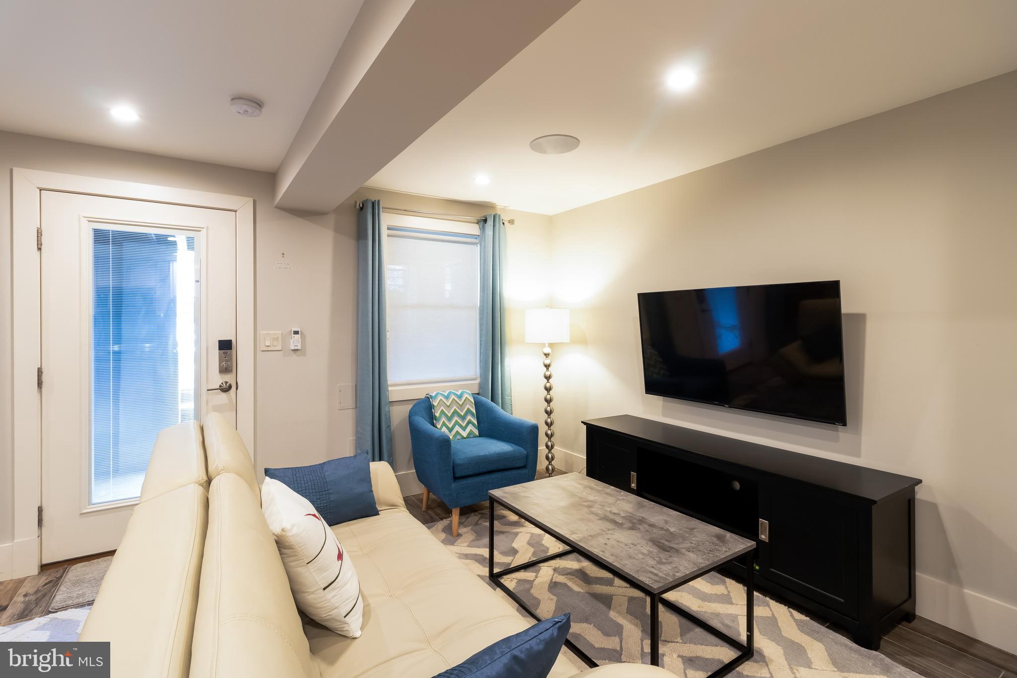 4514 15th Street Northwest, Unit B Washington, DC 20011 - Photo 22 of 34 a living room with furniture and a flat screen tv