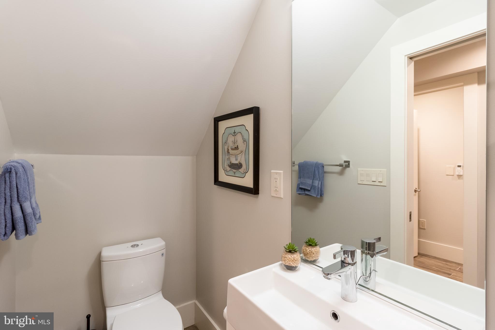 4514 15th Street Northwest, Unit B Washington, DC 20011 - Photo 10 of 34 a bathroom with a toilet a sink and mirror