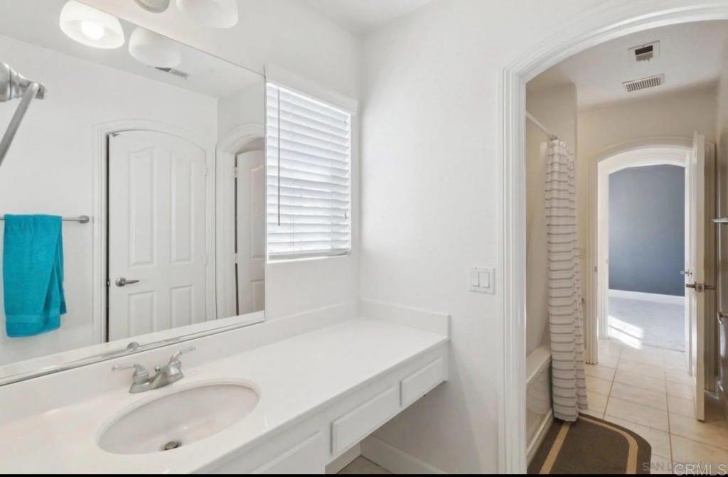 1234 Old Janal Ranch Road Chula Vista, CA 91915 - Photo 21 of 34 a bathroom with a sink and a mirror
