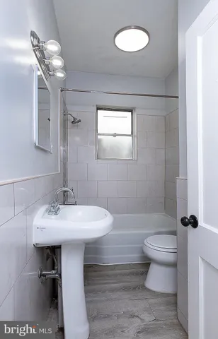 a bathroom with a sink toilet and a mirror