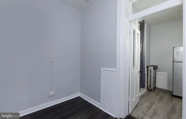 a view of a room with wooden floor