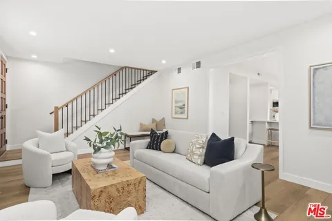 a living room with furniture and a potted plant