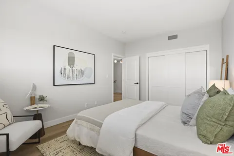 a bedroom with a bed and a couch