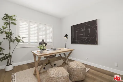 a workspace with furniture and a potted plant