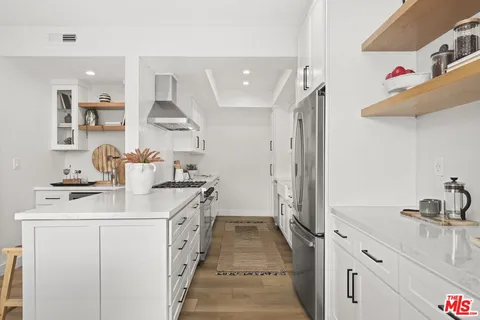 a kitchen with a sink stove and refrigerator