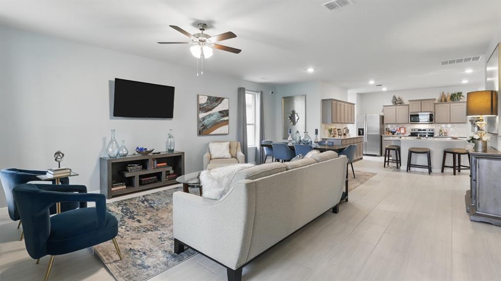 705 Amber Flds Drive Ponder, TX 76259 - Photo 13 of 35 a living room with furniture a flat screen tv and kitchen view