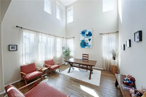 a living room with a bed furniture and a large window