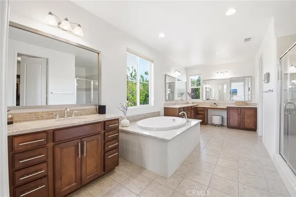 a spacious bathroom with a granite countertop sink and a mirror