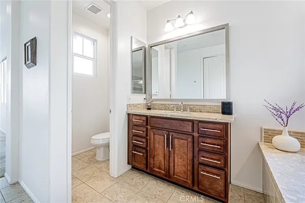 a room with a bed and a chandelier