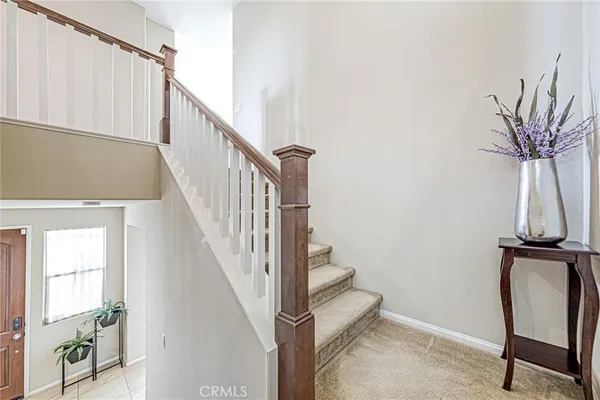 a view of a patio with couches table and chairs and potted plants