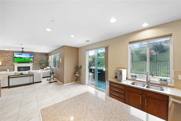 a kitchen with granite countertop stainless steel appliances and wooden cabinets