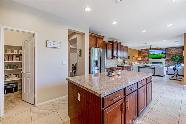 a kitchen with stainless steel appliances granite countertop a refrigerator sink and cabinets