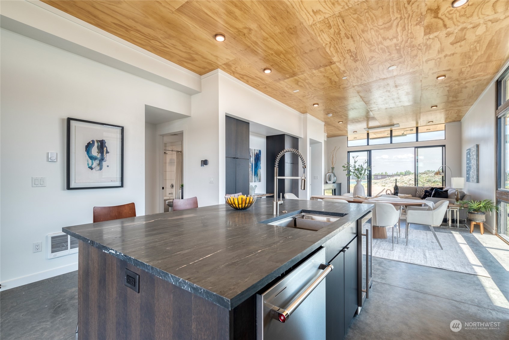 a kitchen with a table chairs and wooden floor