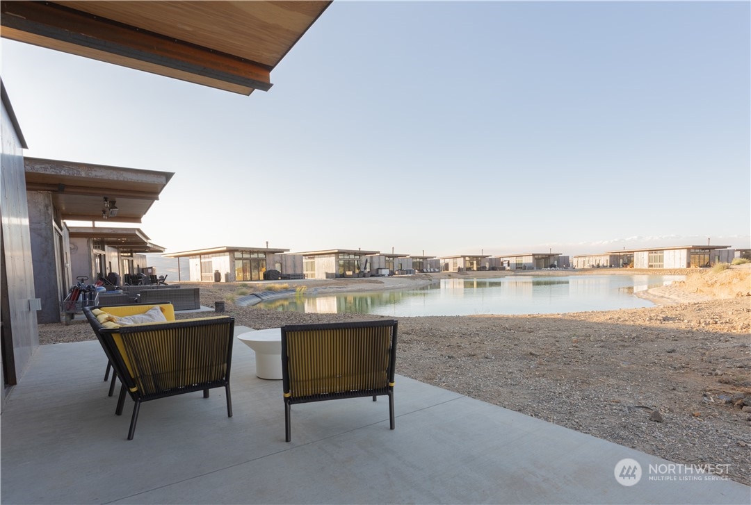 228 (lot 32) Nw Rattlesnake Point Road Quincy, WA 98848 - Photo 18 of 38 a view of a terrace with furniture and a lake view