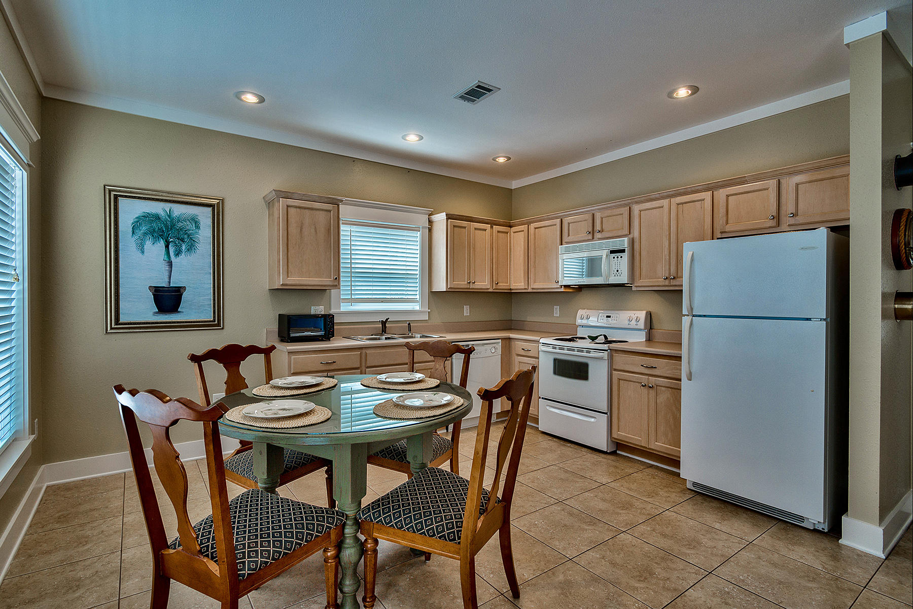 171 Chivas Lane Santa Rosa Beach, FL 32459 - Photo 24 of 32 a kitchen with a refrigerator a stove a dining table and chairs