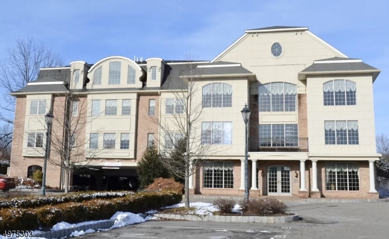 a front view of a residential apartment building with a yard