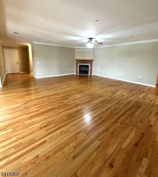 16 Main Street, Unit 1 Sparta, NJ 07871 - Photo 12 of 28 an empty room with wooden floor and a ceiling fan