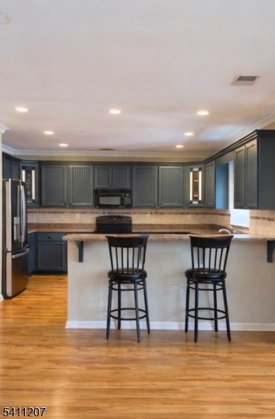 16 Main Street, Unit 1 Sparta, NJ 07871 - Photo 19 of 28 a kitchen with a table chairs a sink dishwasher window and cabinets