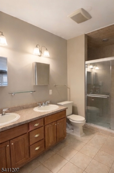 16 Main Street, Unit 1 Sparta, NJ 07871 - Photo 20 of 28 a bathroom with a toilet sink and mirror
