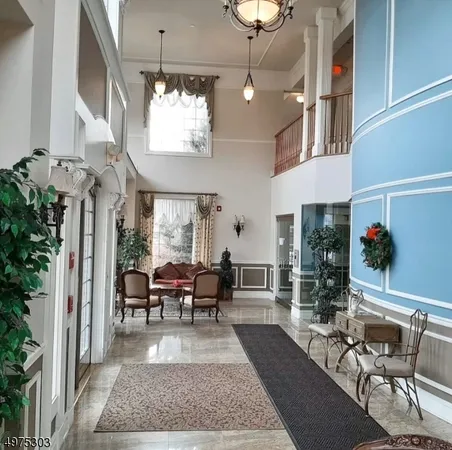 a living room with furniture chandelier and window