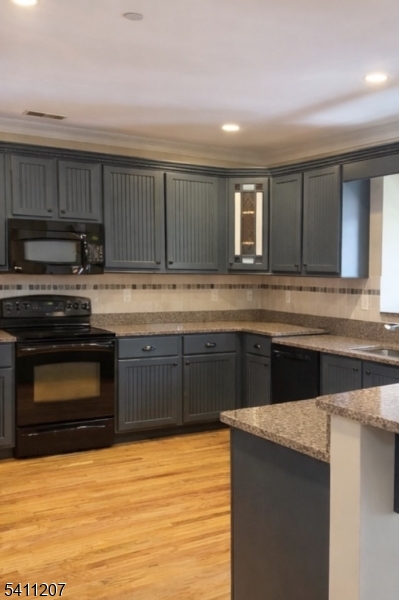 16 Main Street, Unit 1 Sparta, NJ 07871 - Photo 22 of 28 a kitchen with stainless steel appliances granite countertop a stove a sink and a microwave