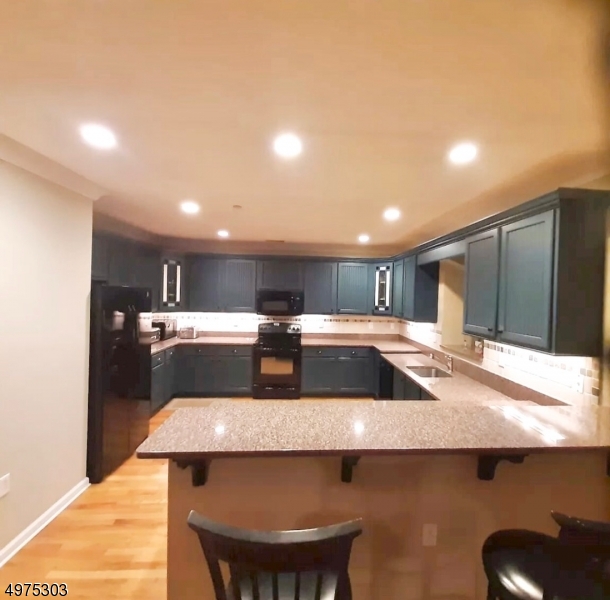 16 Main Street, Unit 1 Sparta, NJ 07871 - Photo 6 of 28 a open kitchen with a table and chairs