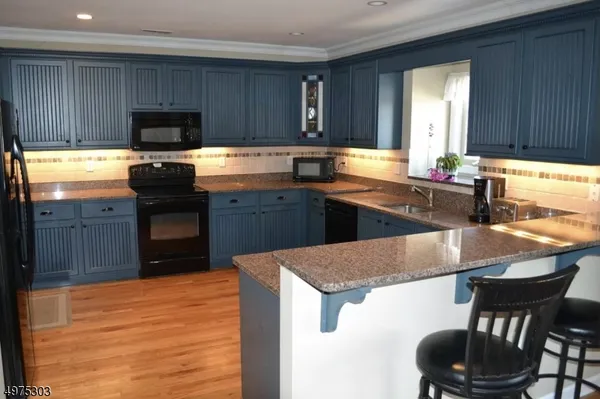 a kitchen with stainless steel appliances granite countertop a sink counter space and cabinets