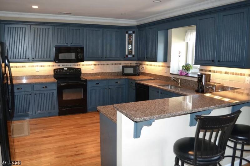 16 Main Street, Unit 1 Sparta, NJ 07871 - Photo 7 of 28 a kitchen with stainless steel appliances granite countertop a sink counter space and cabinets