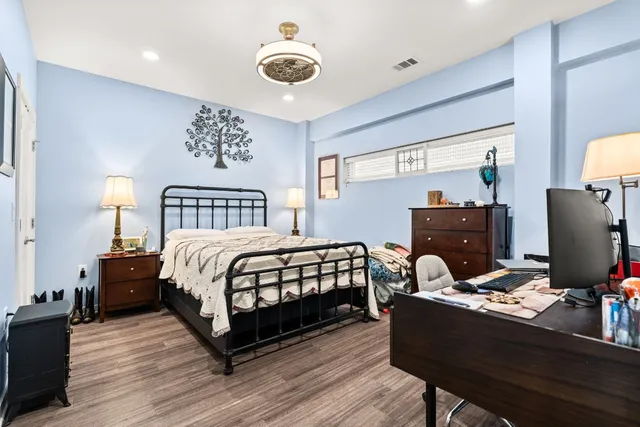 a bedroom with a bed and a desk