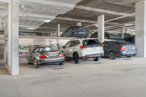 a view of parking garage with cars parked