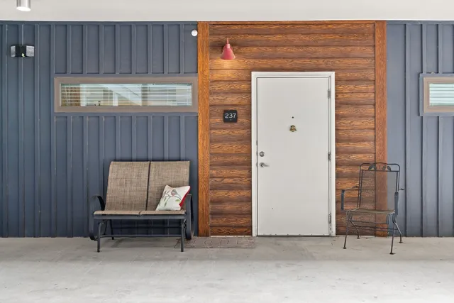 a bench sitting in front of a door