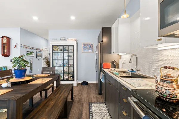 a kitchen with sink stove and cabinets