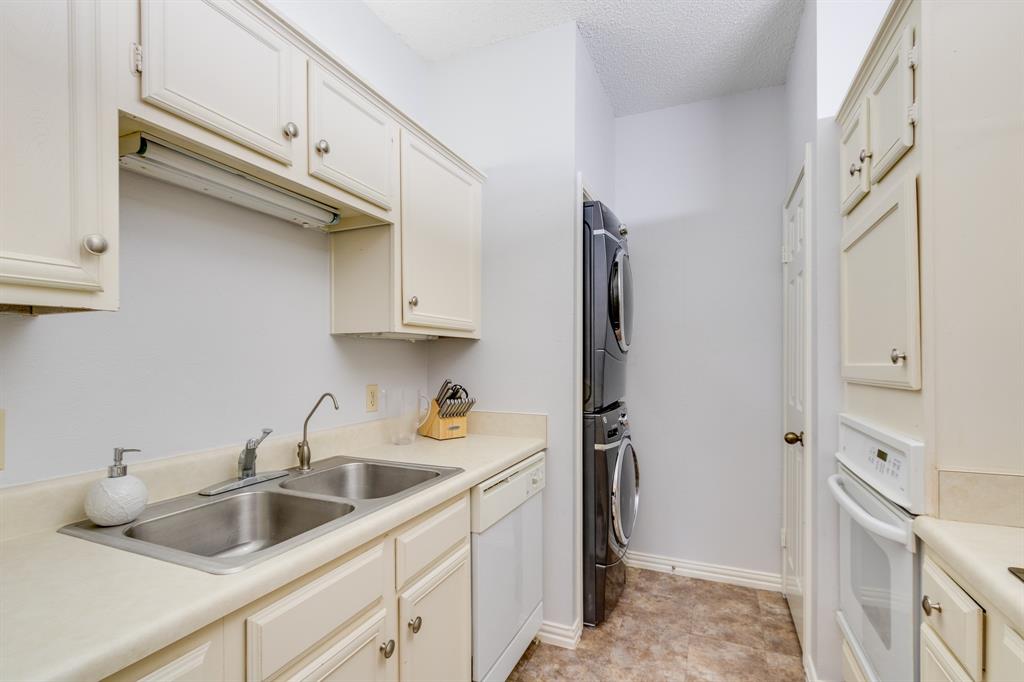 2100 Randy Snow Road, Unit 412 Arlington, TX 76011 - Photo 13 of 32 a kitchen with white cabinets and a sink