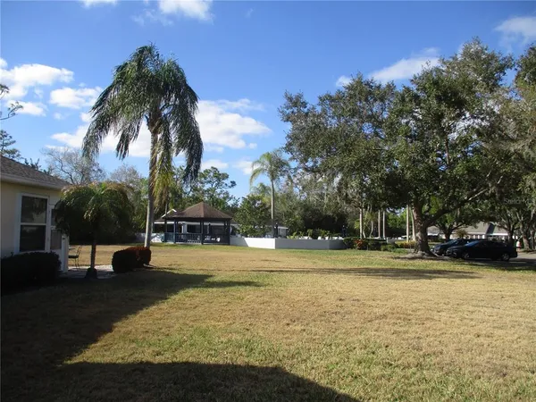 a swimming pool with outdoor seating and yard