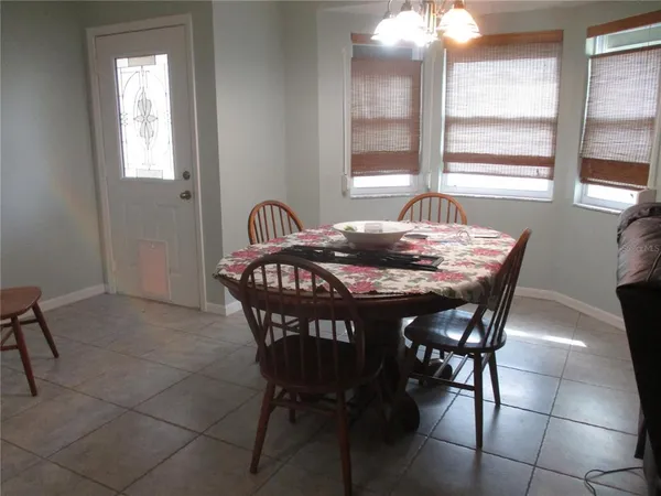 a dining room with furniture and window