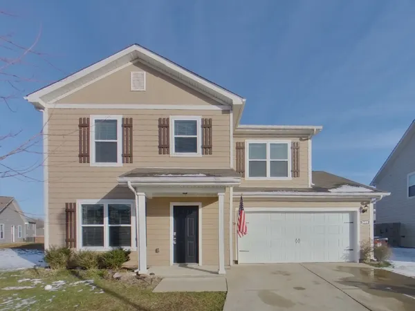 a front view of a house with a garage