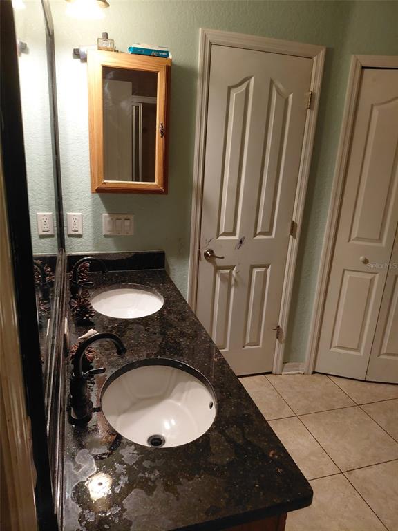 11382 Mahopac Road Weeki Wachee, FL 34614 - Photo 14 of 35 a bathroom with a sink and a mirror