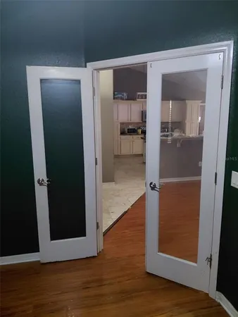 a view of a hallway with wooden floor