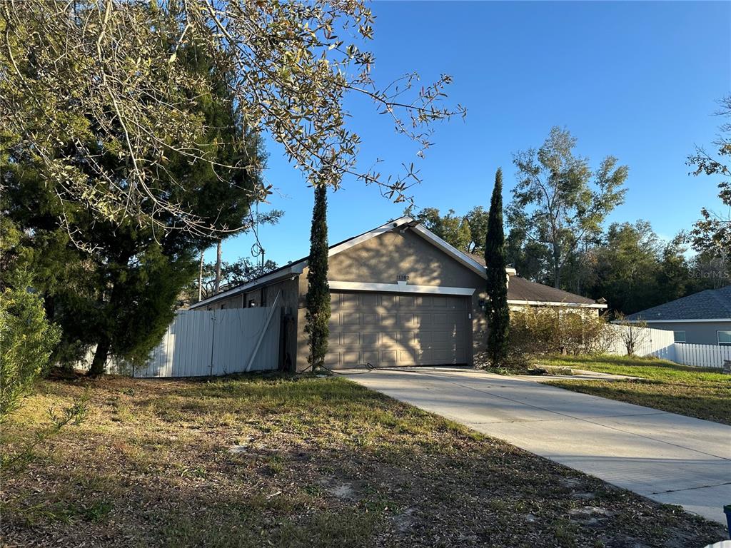 11382 Mahopac Road Weeki Wachee, FL 34614 - Photo 2 of 35 a front view of a house with a yard