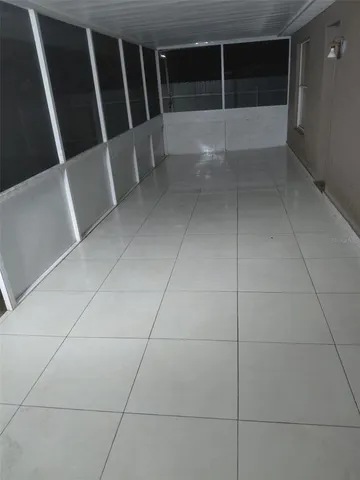 a view of balcony with wooden floor and trees in the background