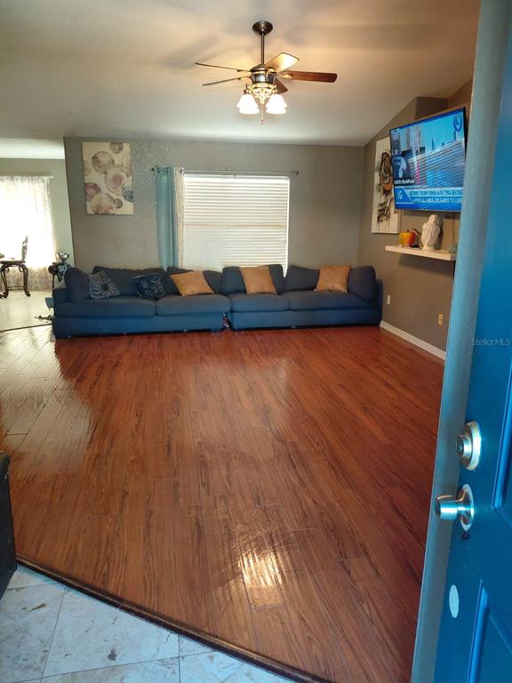 11382 Mahopac Road Weeki Wachee, FL 34614 - Photo 4 of 35 a living room with hard wood floors and a kitchen view