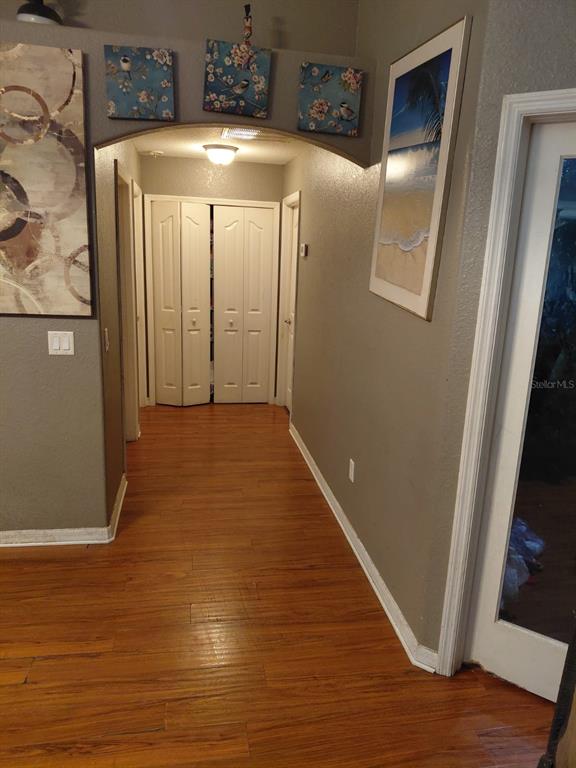 11382 Mahopac Road Weeki Wachee, FL 34614 - Photo 5 of 35 a view of a hallway with wooden floor