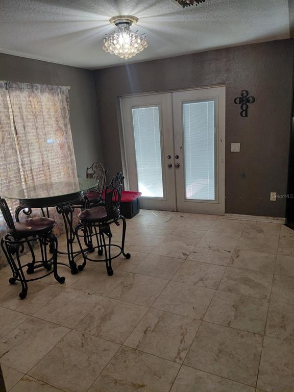 11382 Mahopac Road Weeki Wachee, FL 34614 - Photo 10 of 35 a view of an empty room with furniture and a chandelier