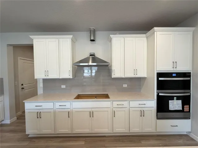 a kitchen with granite countertop a stove a sink and a granite counter tops
