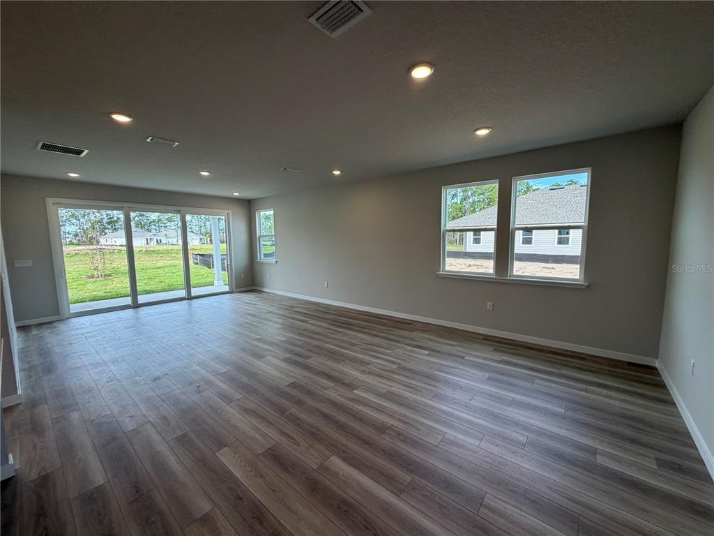 57 Pegasus Road Flagler Beach, FL 32136 - Photo 14 of 45 an empty room with wooden floor and windows