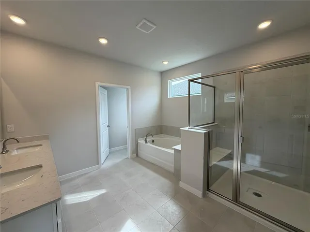 a bathroom with a tub and a shower