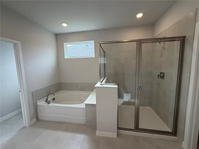 a bathroom with a tub and a shower