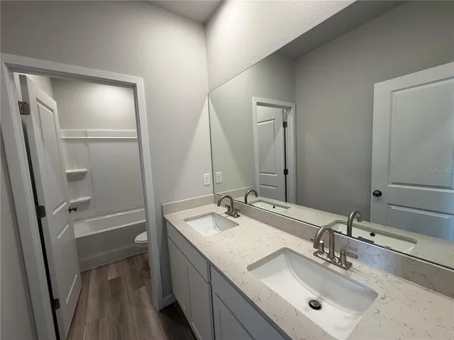 a bathroom with a sink a mirror and a toilet