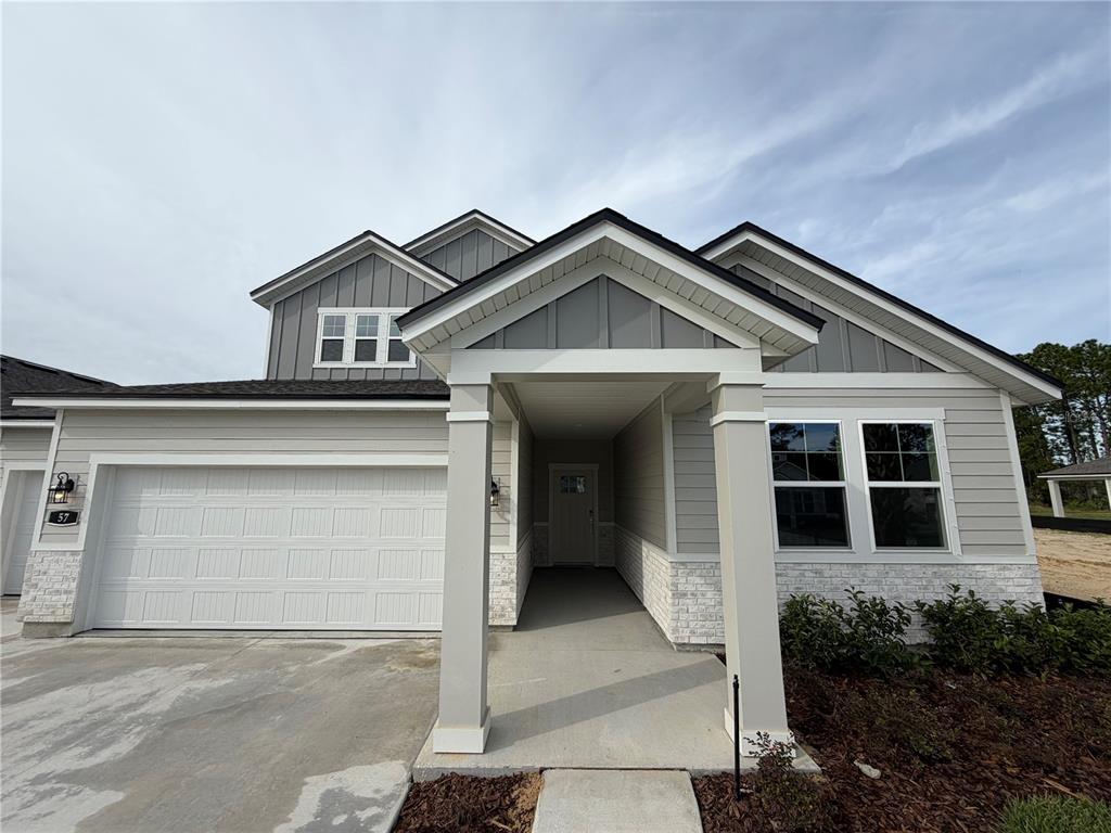 57 Pegasus Road Flagler Beach, FL 32136 - Photo 4 of 45 a front view of a house with garden